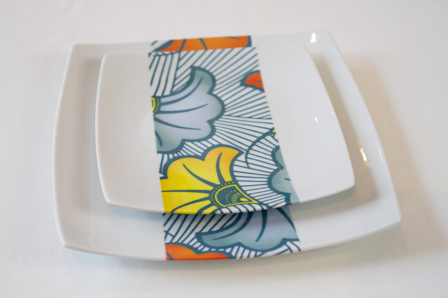 Coffret d'assiettes en porcelaine fine Française fabriquées à la demande avec motif bande WAX d'afrique "Grandes Fleurs de Mariage" dans coffret de 12